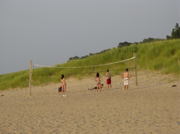 Couples playing volleyball on the beach