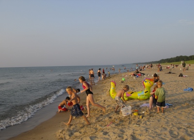 New Buffalo Michigan beach with children going swimming